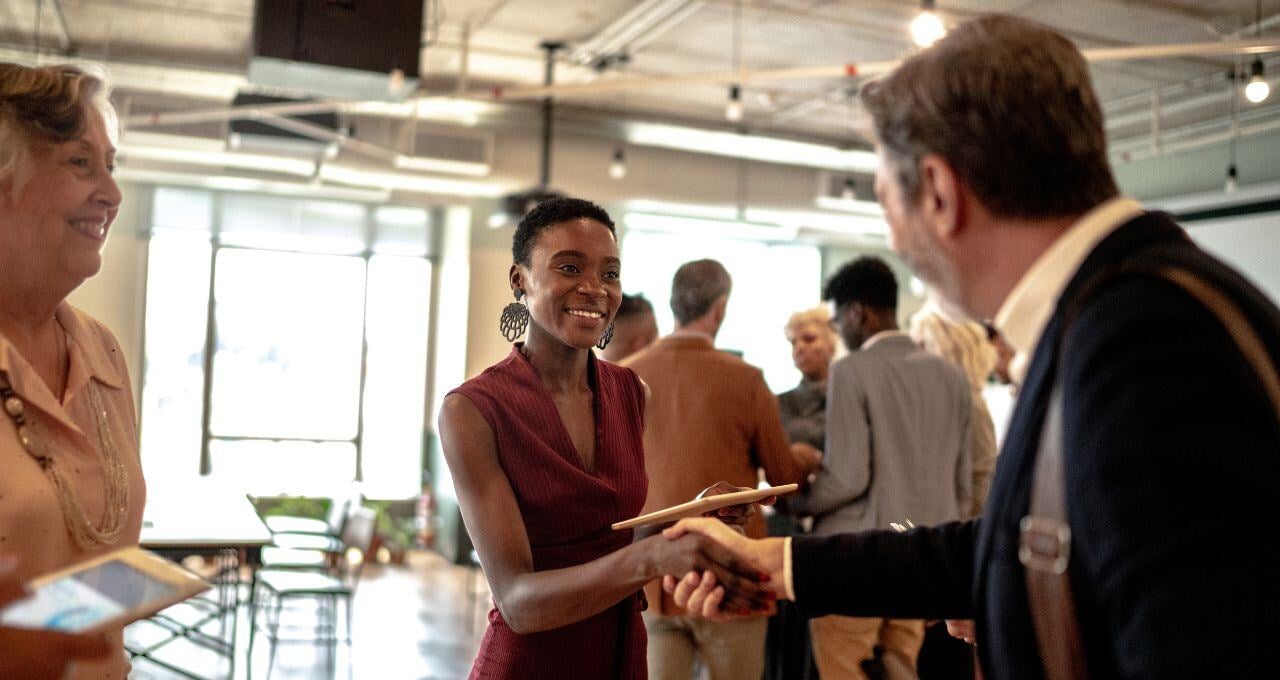 two people shaking hands at an event