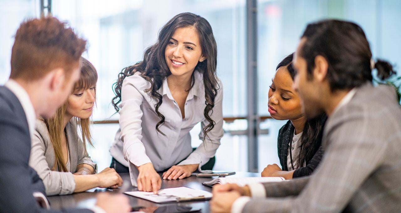 Women explaining information during meeting